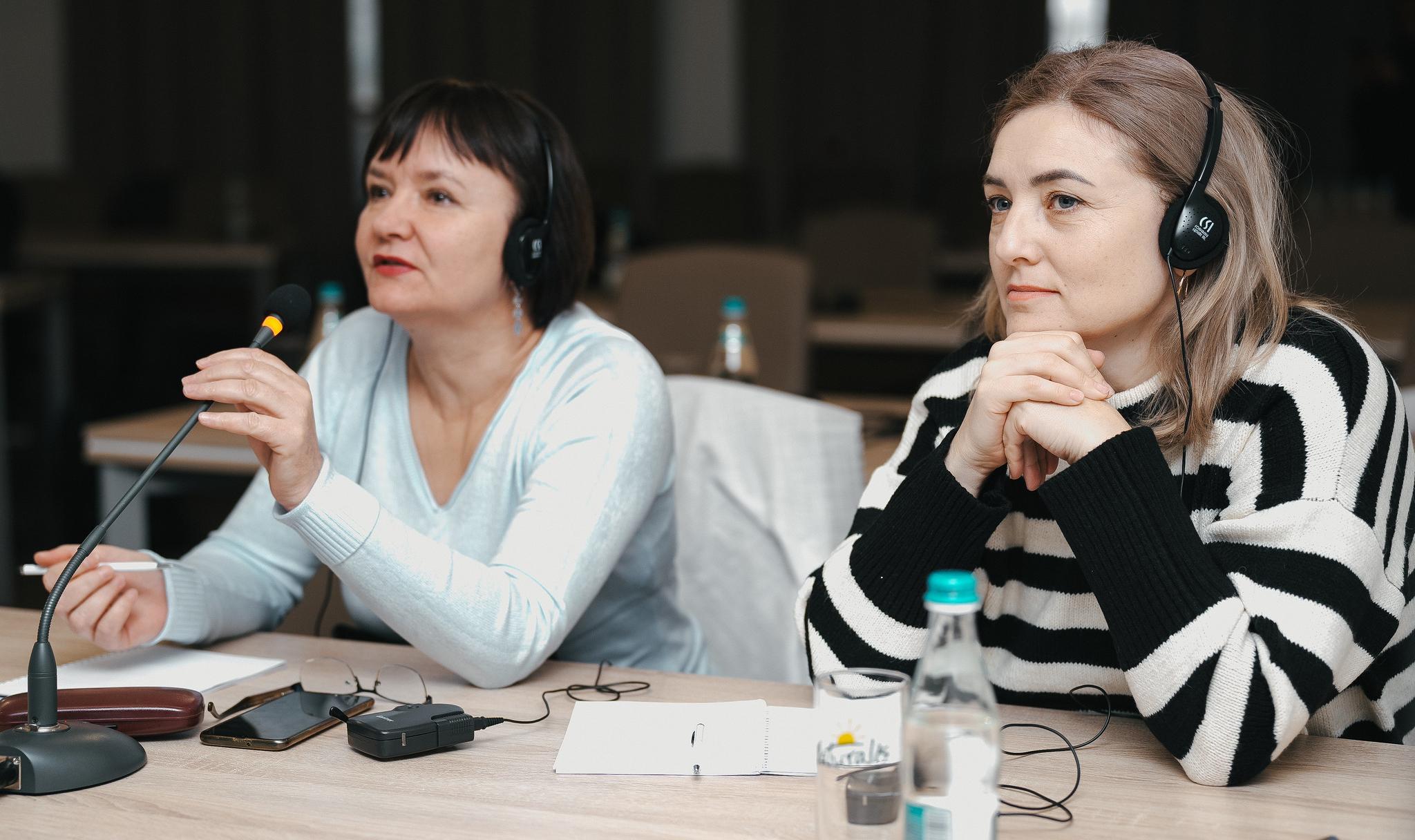 Two participants listen to a training