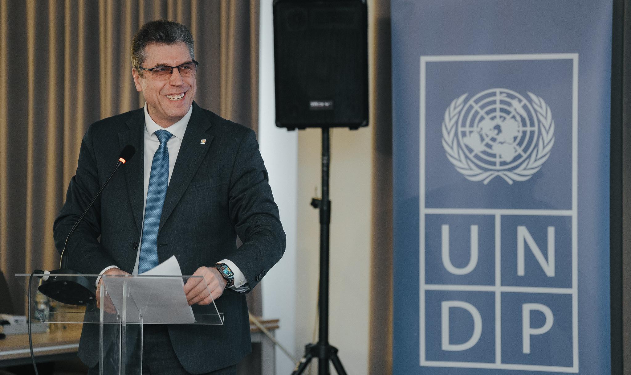 Participant speaks in front of UNDP banner