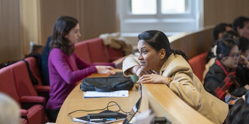 Participant leans over a desk